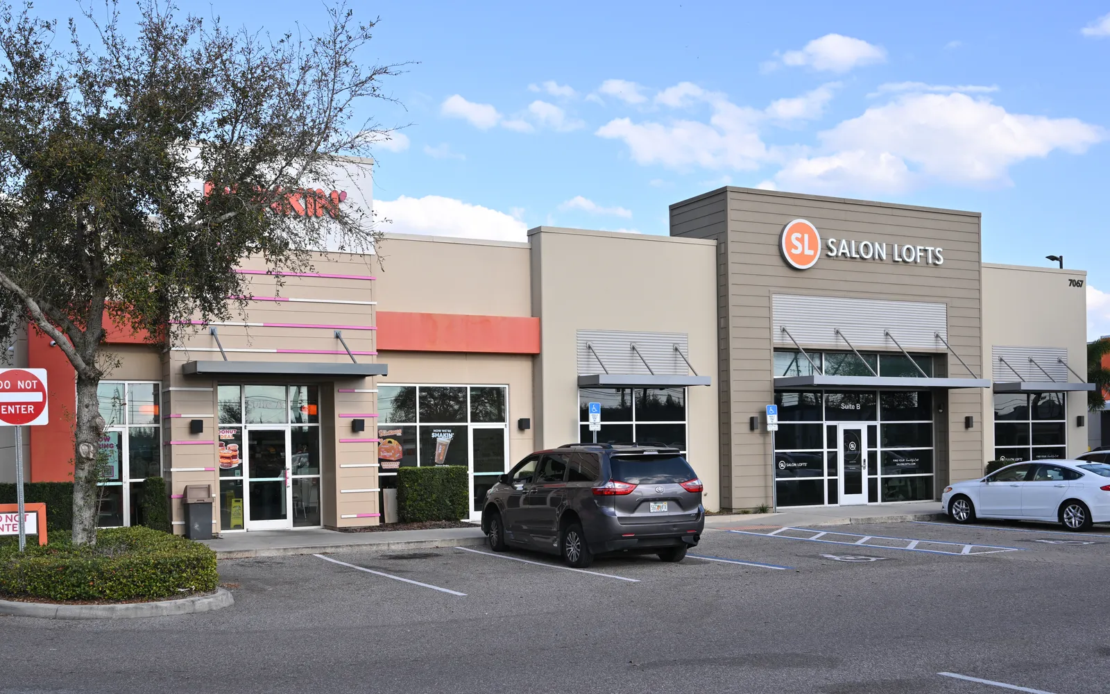 Multi-tenant strip center with storefronts and parking.