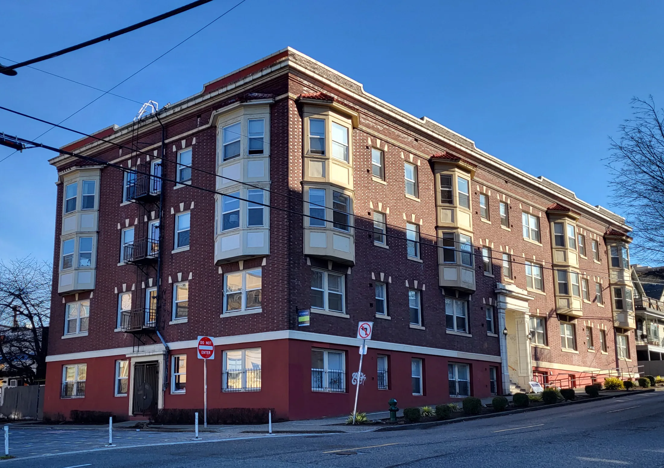Four-story brick apartment building on a city corner